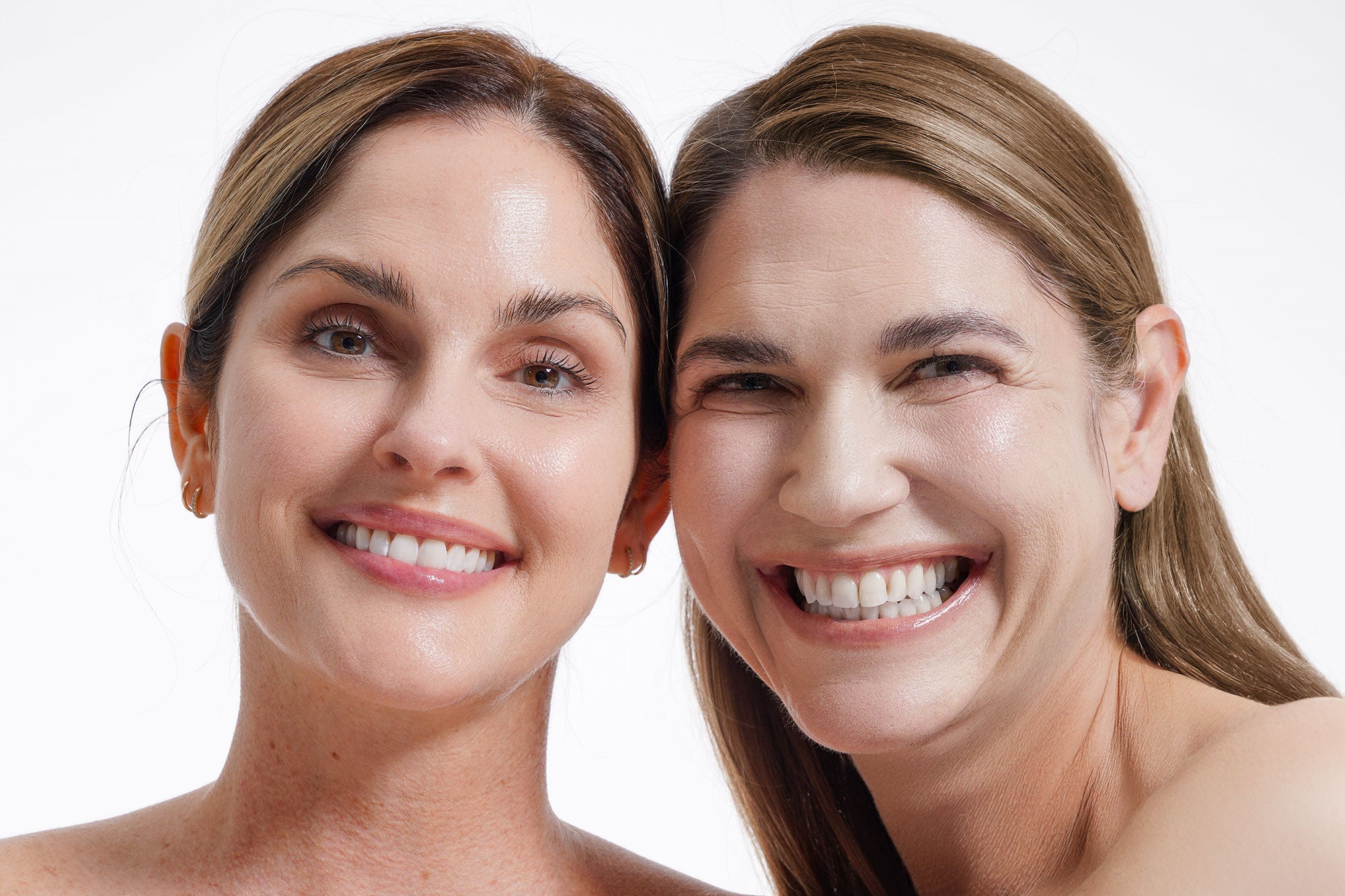 Two women side by side, smiling towards camera.