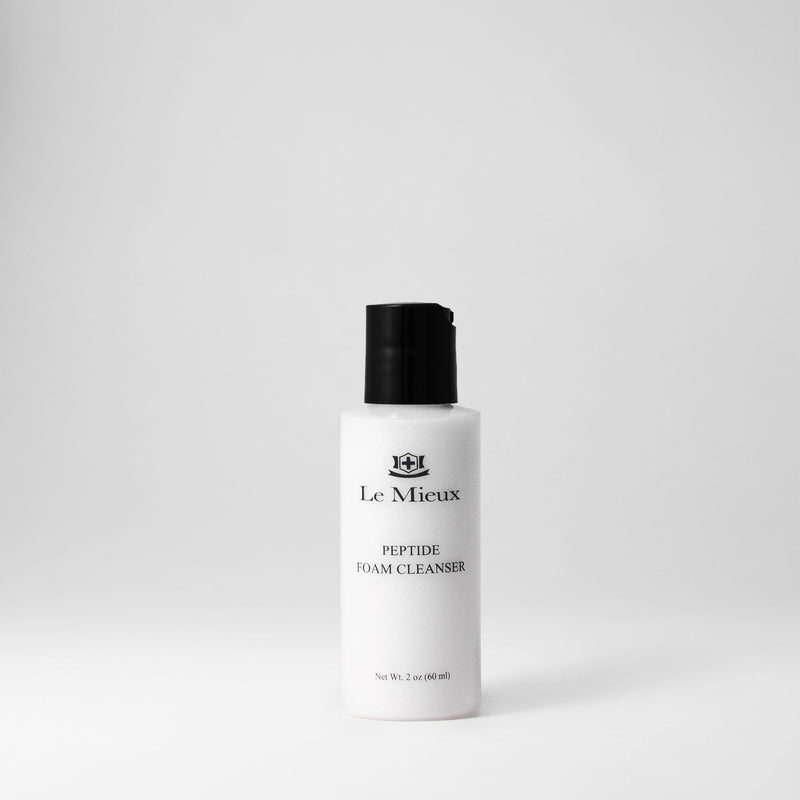 2 oz white bottle with black cap of Peptide Foam Cleanser isolated on light gray background